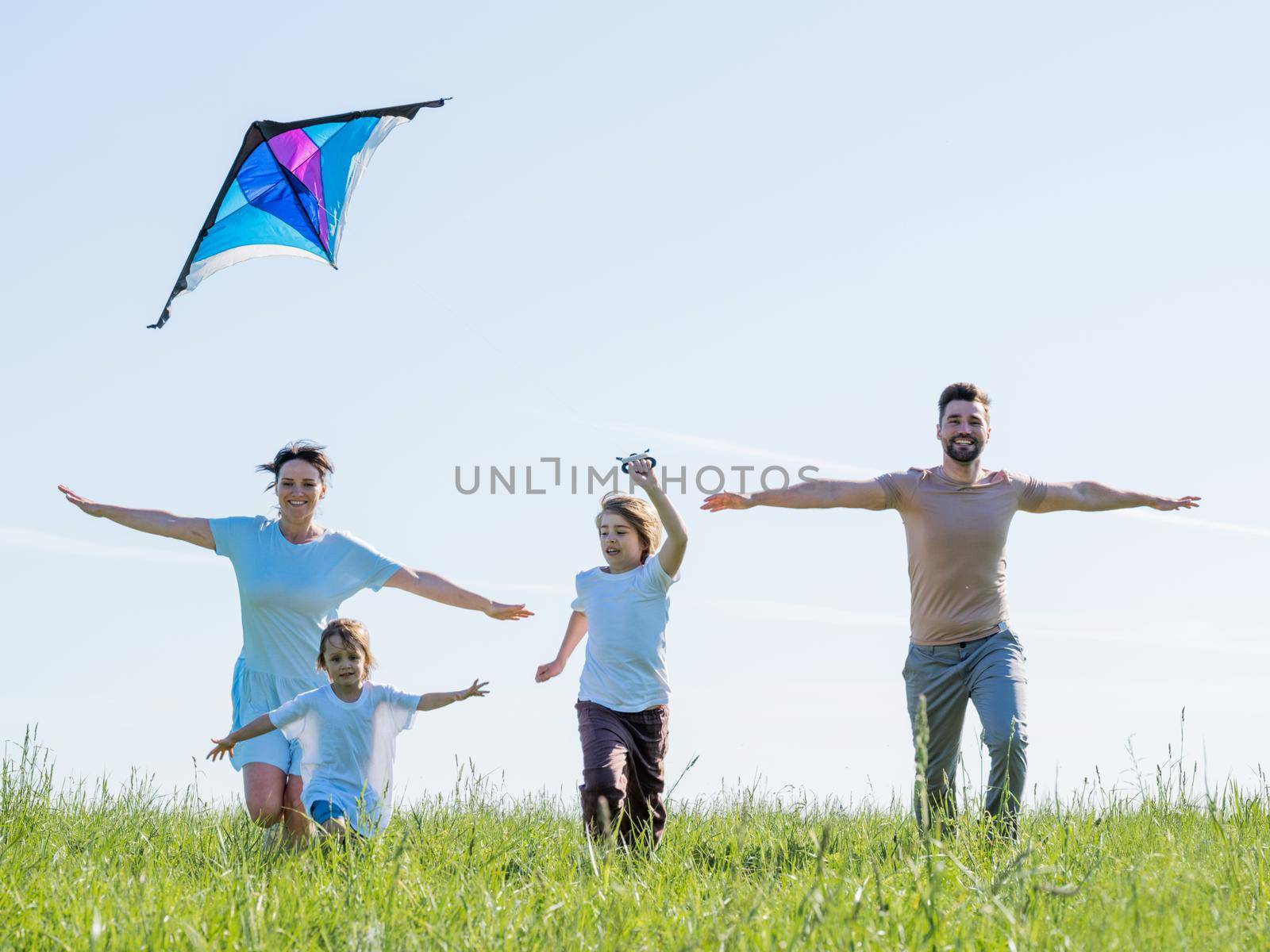 Family running with outstretched arms by ALotOfPeople