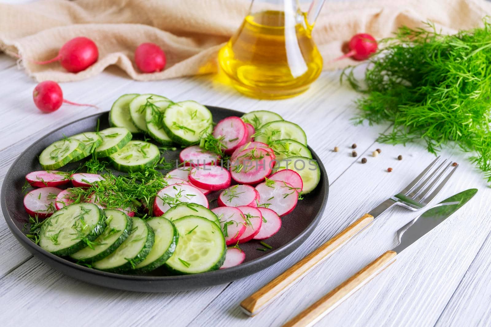 Fresh cucumber and radish salad with dill and vegetable oil. Vegetarian diet. Diesta for weight loss. Healthy eating. Selective focus.