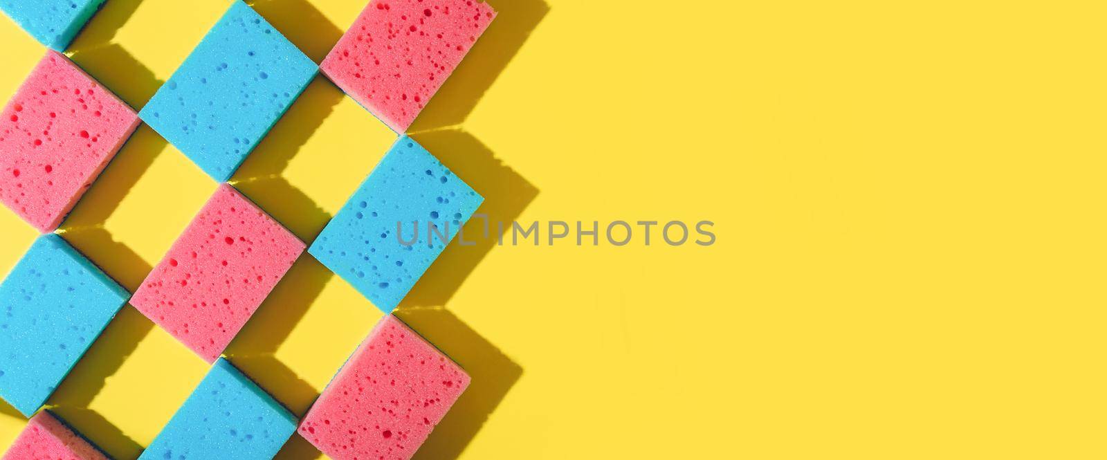 House cleaning sponges on yellow background by fascinadora