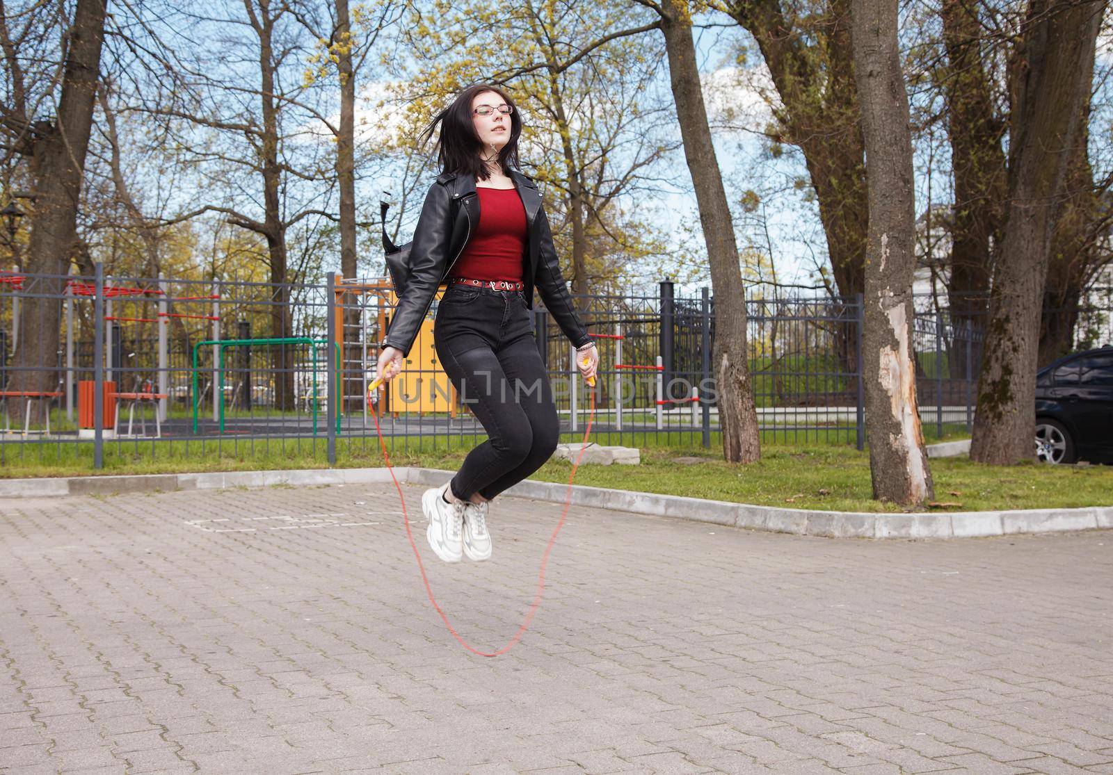young brunette girl jumping rope outdoor by raddnatt