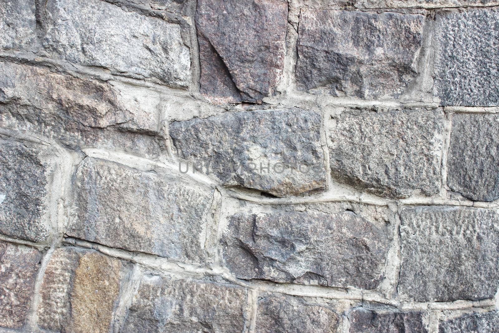 old wall of large stones outdoor closeup. abstract background