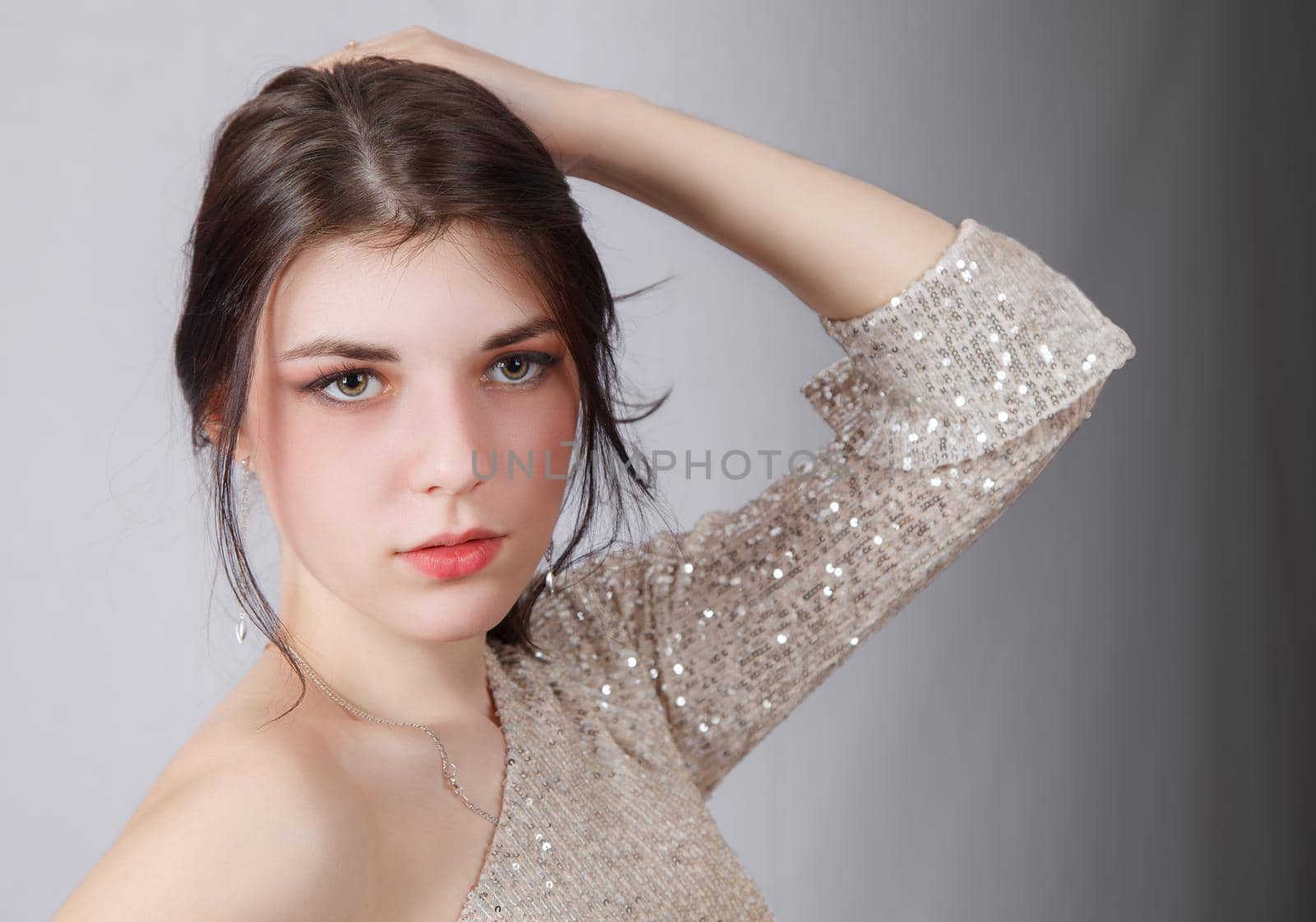 portrait of a young beautiful girl in bright dress in studio by raddnatt