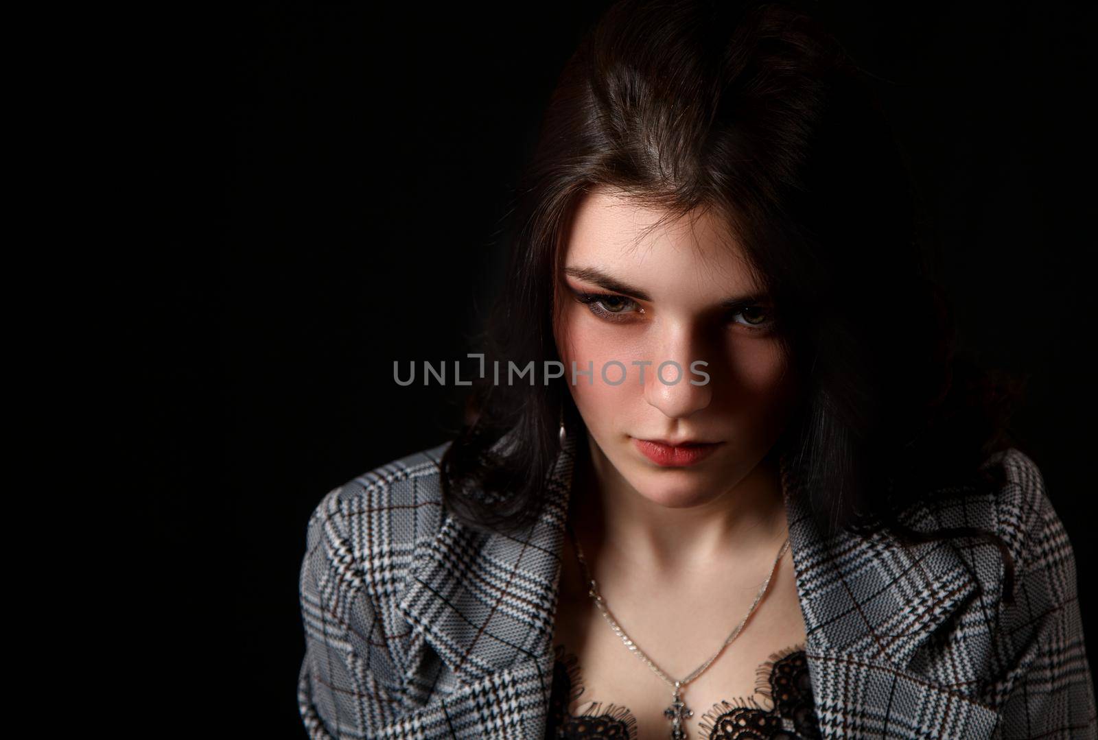portrait of a young beautiful brunette girl in studio by raddnatt