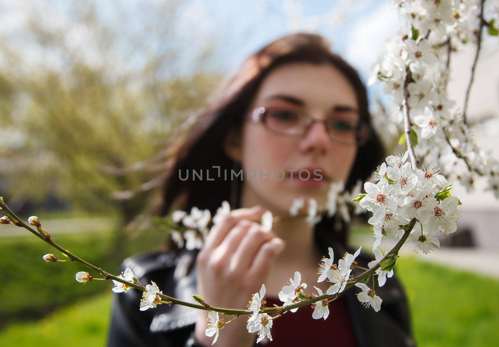 portrait of young girl standing near cherry blossoms by raddnatt