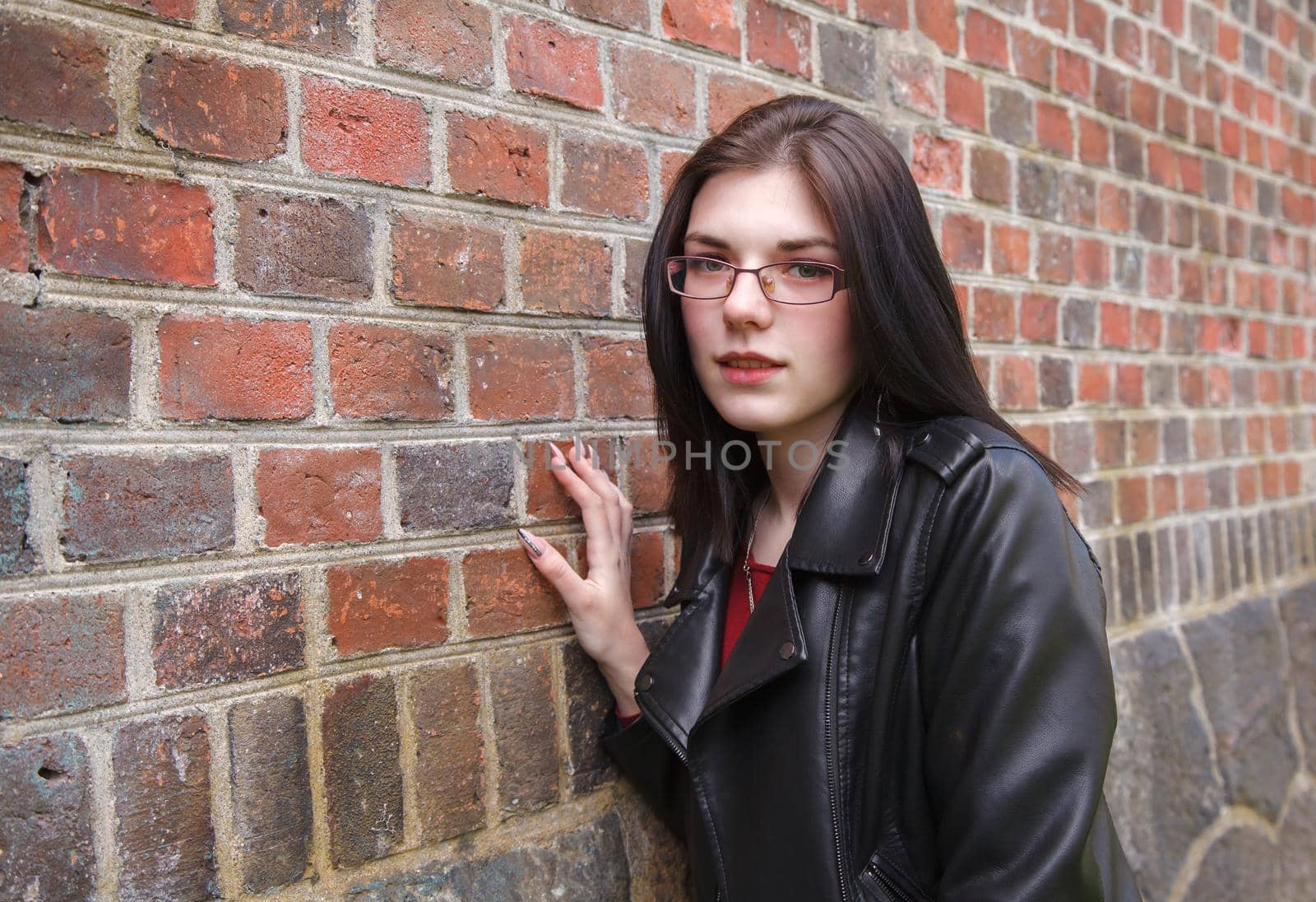 young beautiful girl near the old fortress wall by raddnatt