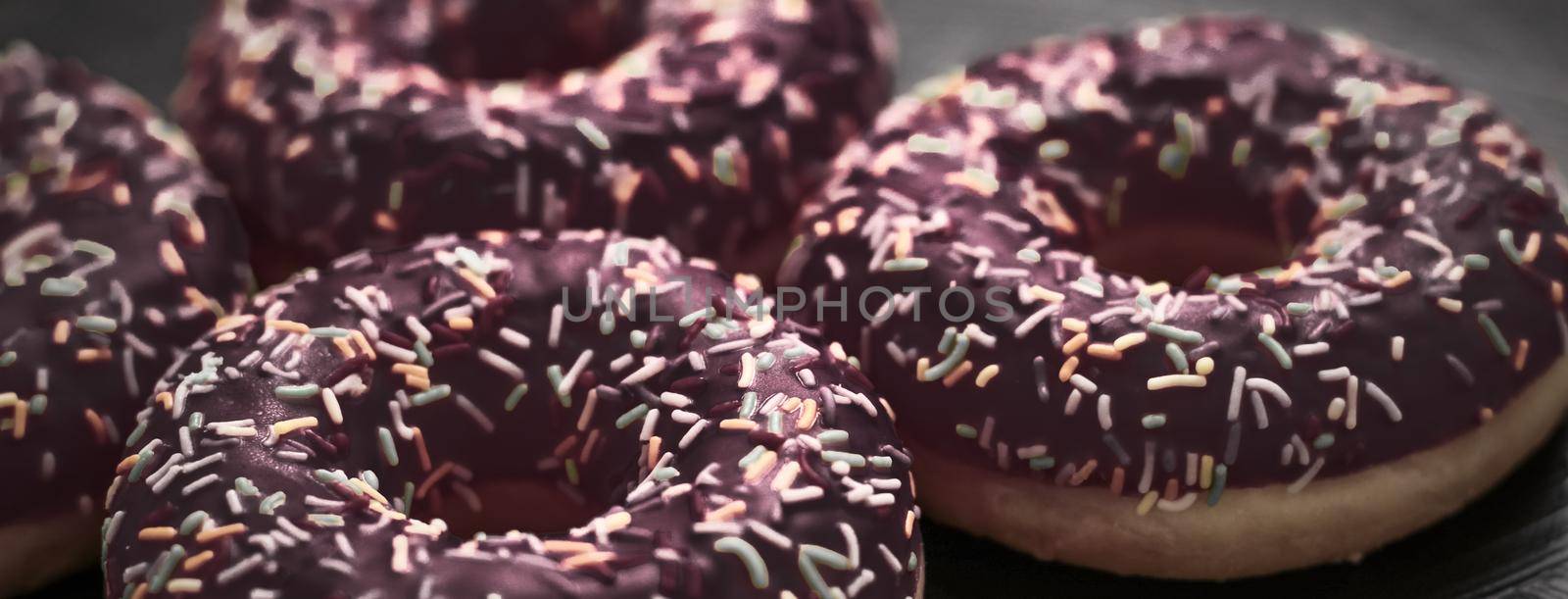 Frosted sprinkled donuts, sweet pastry dessert on rustic wooden background, doughnuts as tasty snack, top view food brand flat lay for blog, menu or cookbook design by Anneleven