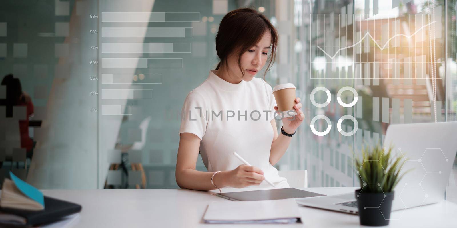 Business woman using application in digital tablet with virtual financial icon on screen