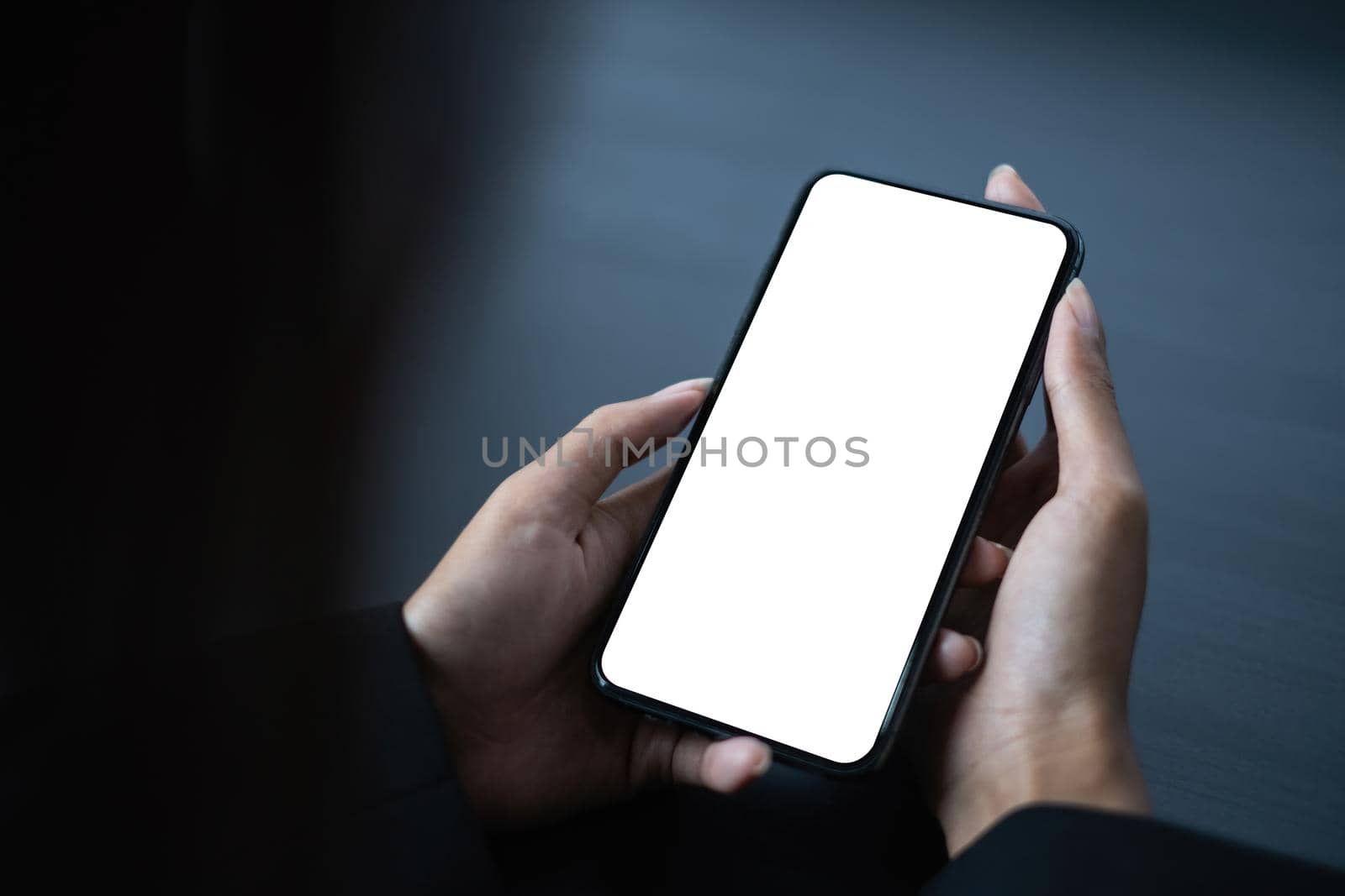 A Man hand holding smartphone device with blank screen