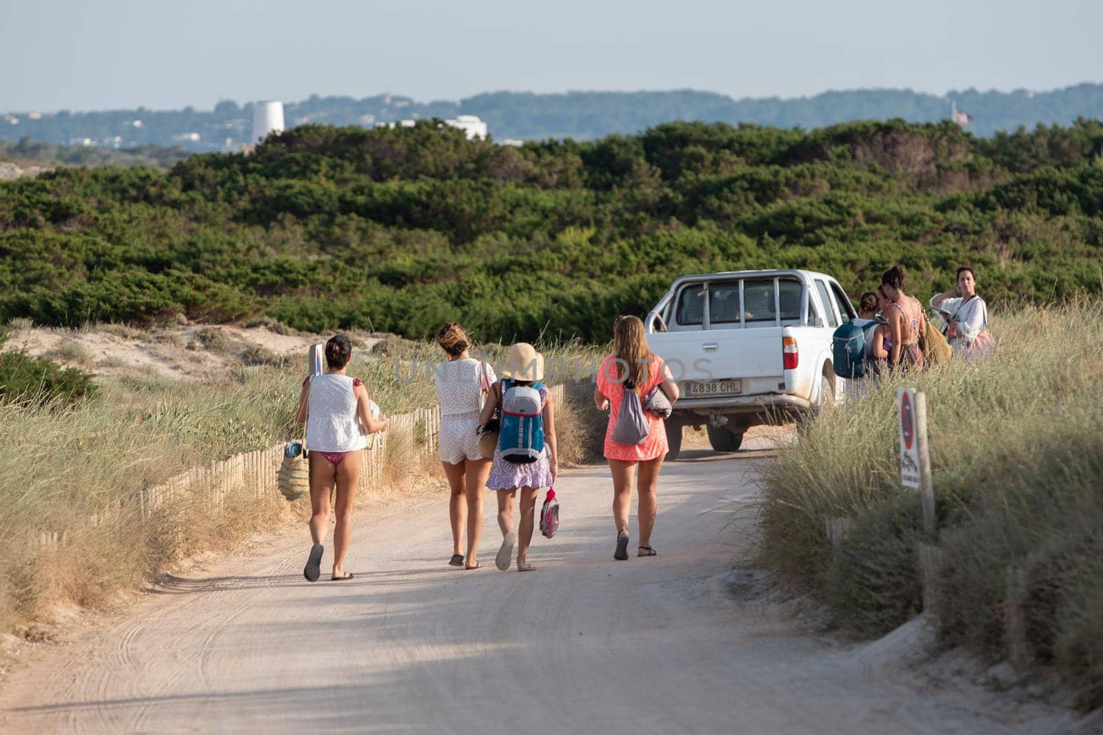 Formentera, Spain: 2021 June 13: Tourists cycling on the Illetes Beach in Formentera in Spain in times of Covid19