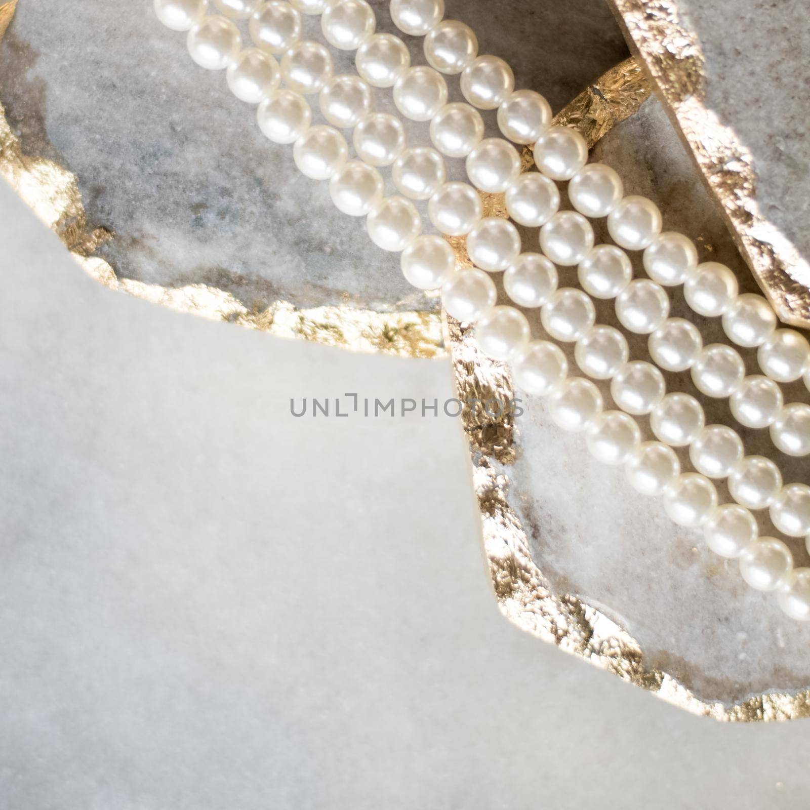 Pearl necklace on golden marble, ethical jewellery - luxury background, jewelry as a gift concept. Pearls are girl's best friends