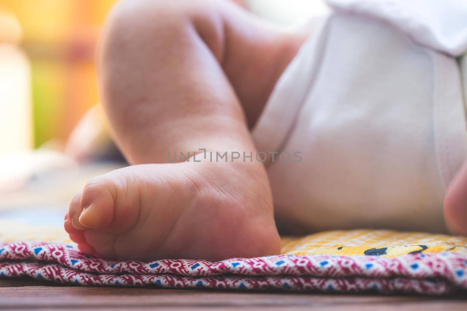 Close up of newborn baby feet, outdoors on baby blanket