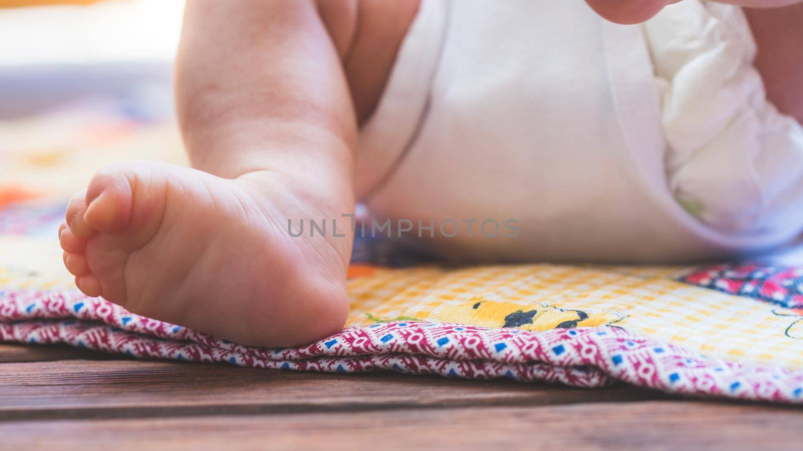 Close up of newborn baby feet, outdoors on baby blanket