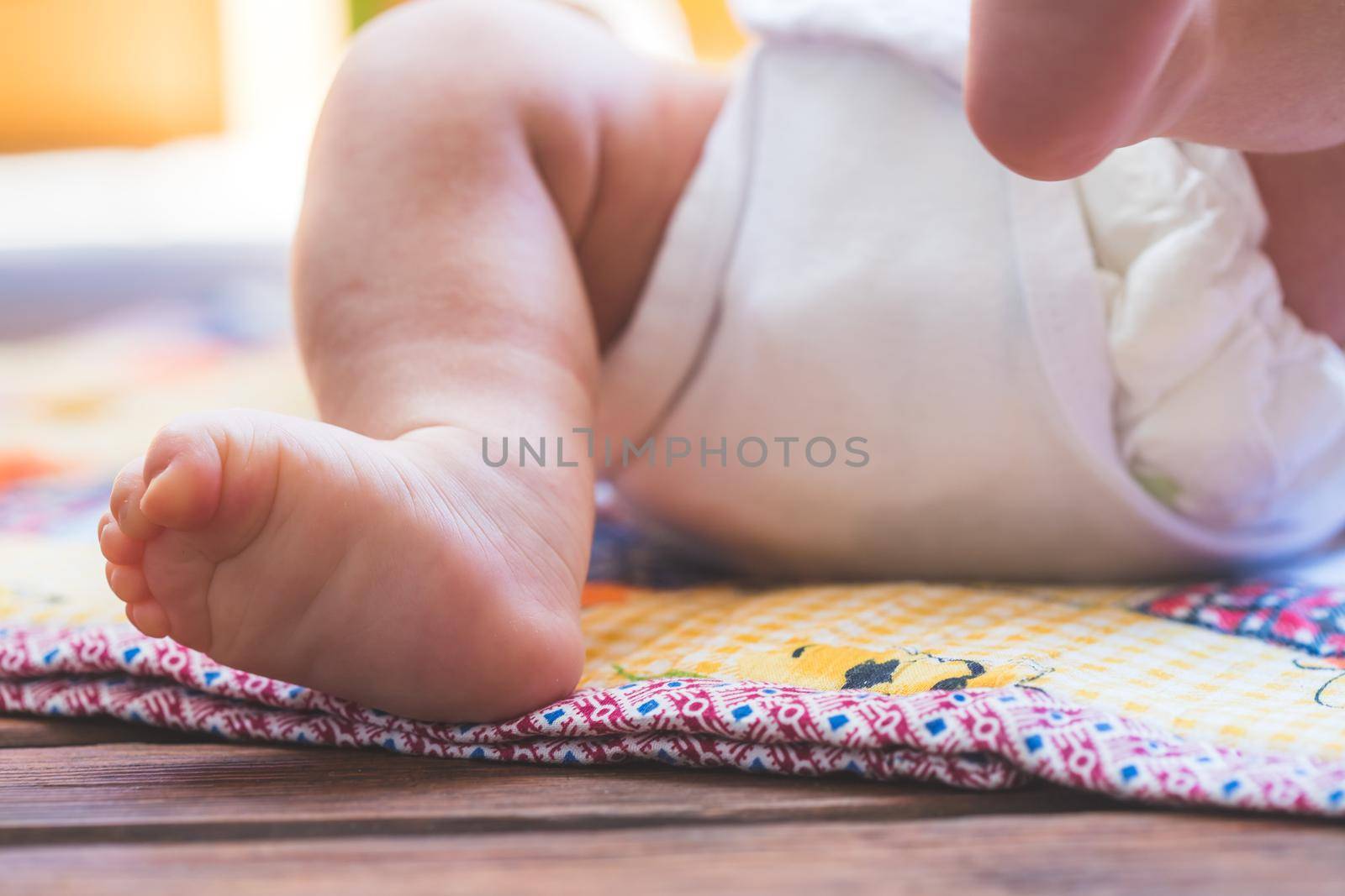 Close up of newborn baby feet, outdoors on baby blanket