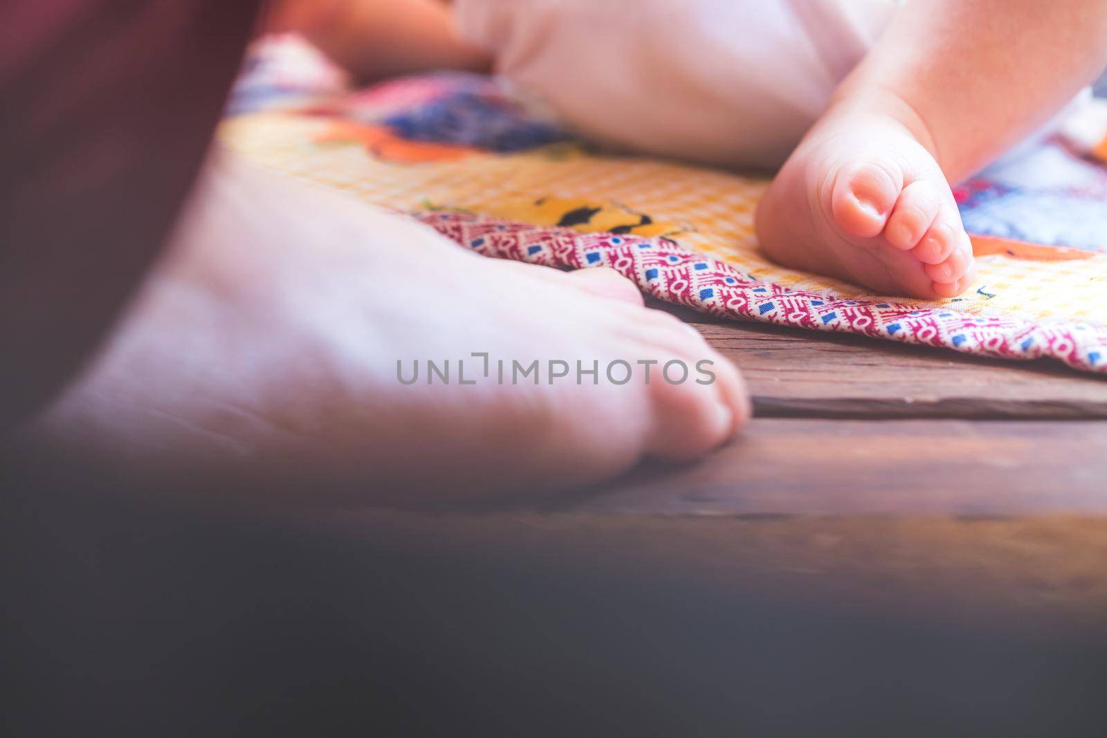 Close up of newborn baby feet, outdoors on baby blanket