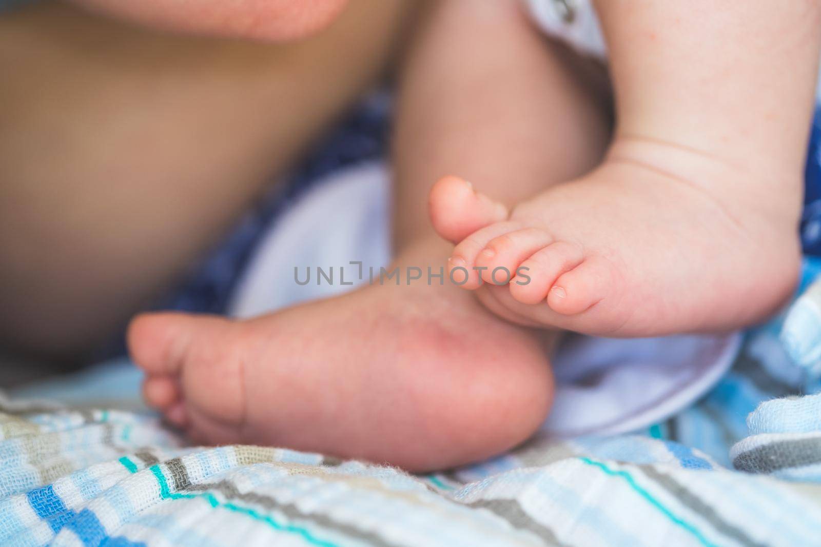 Close up of newborn baby feet on baby blanket