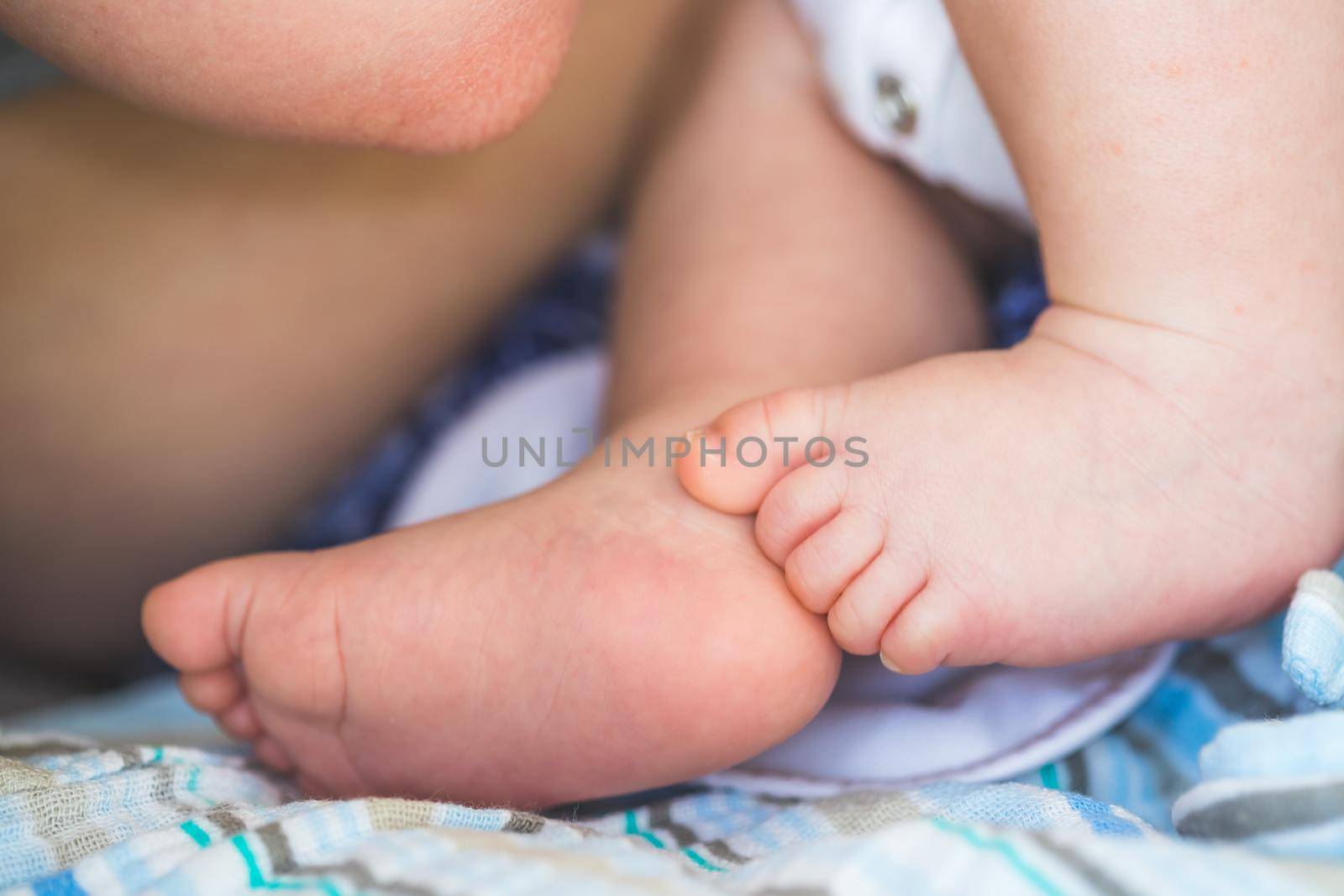 Close up of newborn baby feet on baby blanket