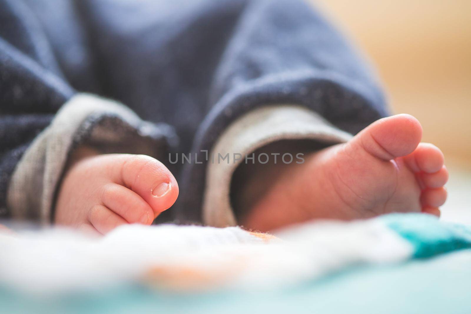 Baby and newborn concept: Close up of newborn baby feet on baby blanket by Daxenbichler