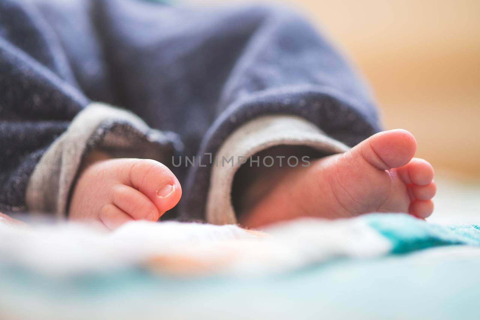 Close up of newborn baby feet on baby blanket