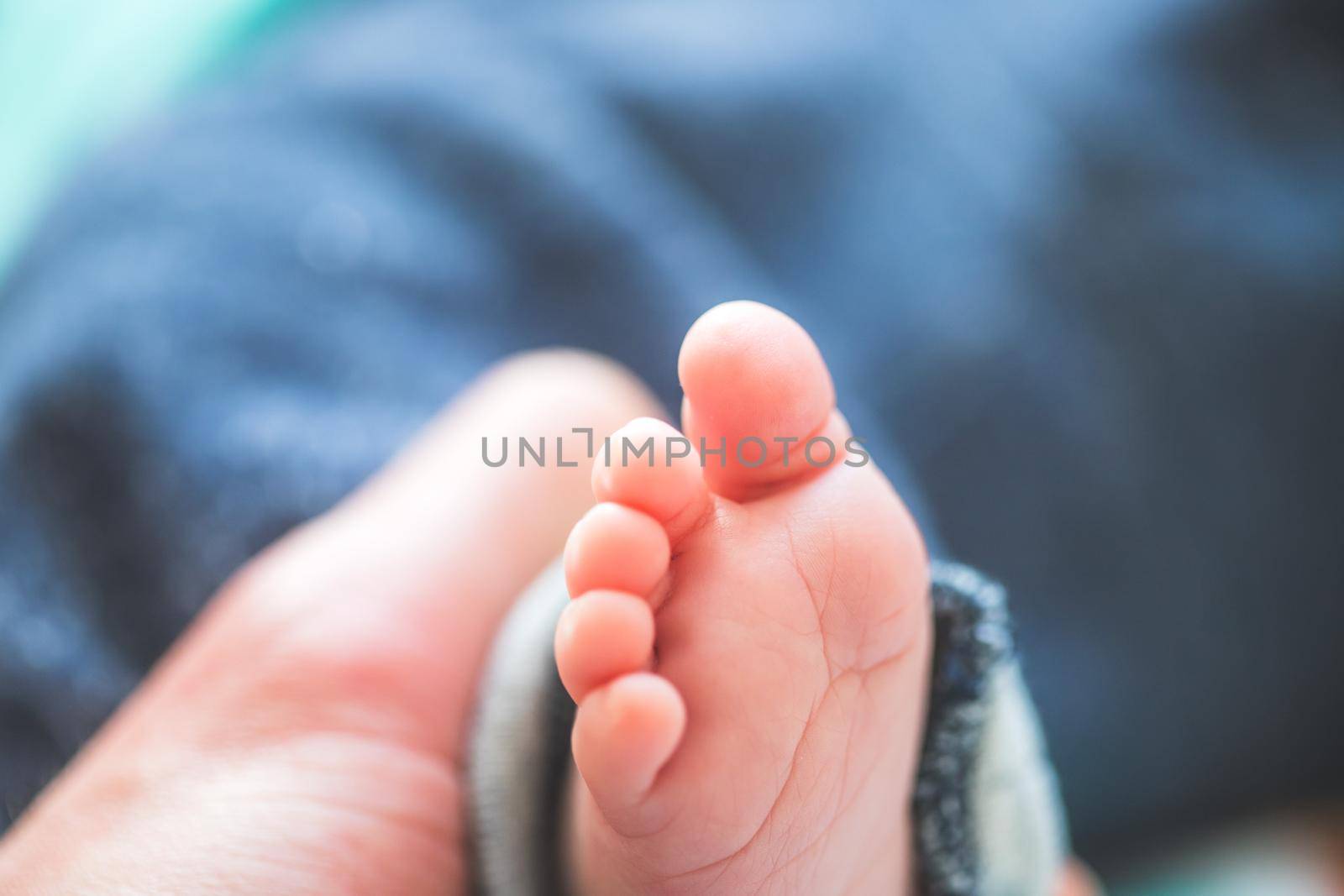 Close up of newborn baby feet on baby blanket