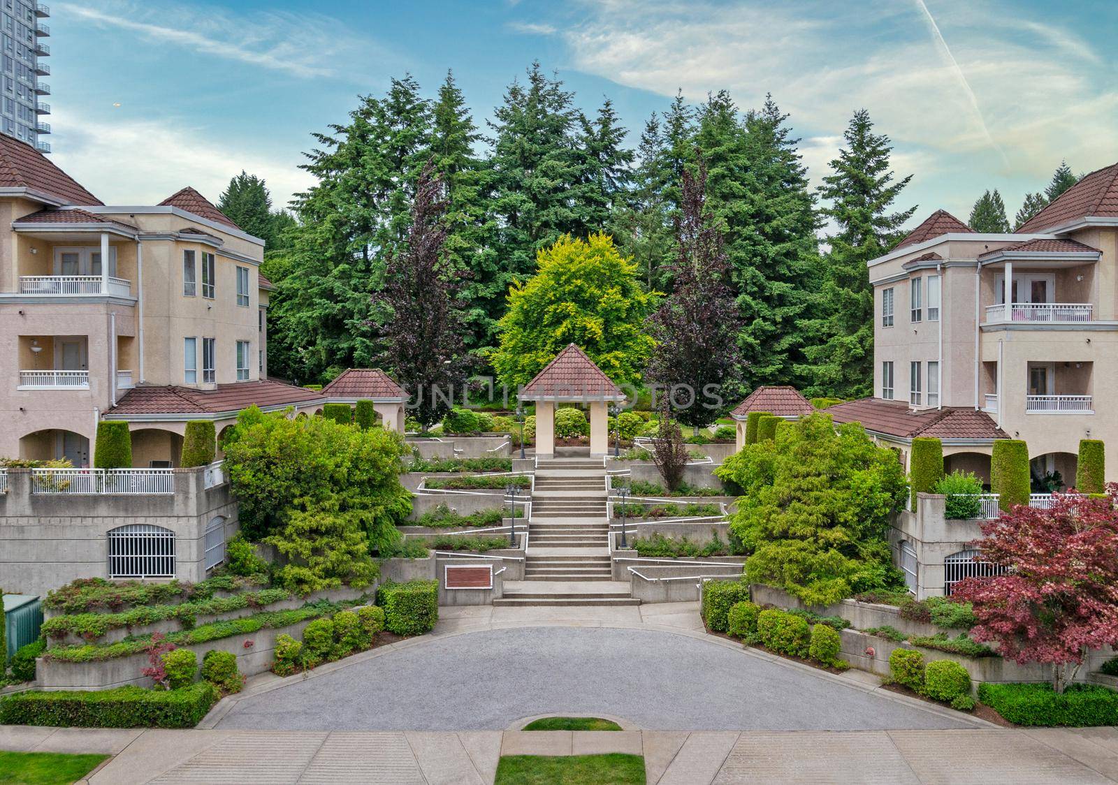 A Perfect Neighbourhood. Italian style low-rise residential building on land terraces on blue sky background