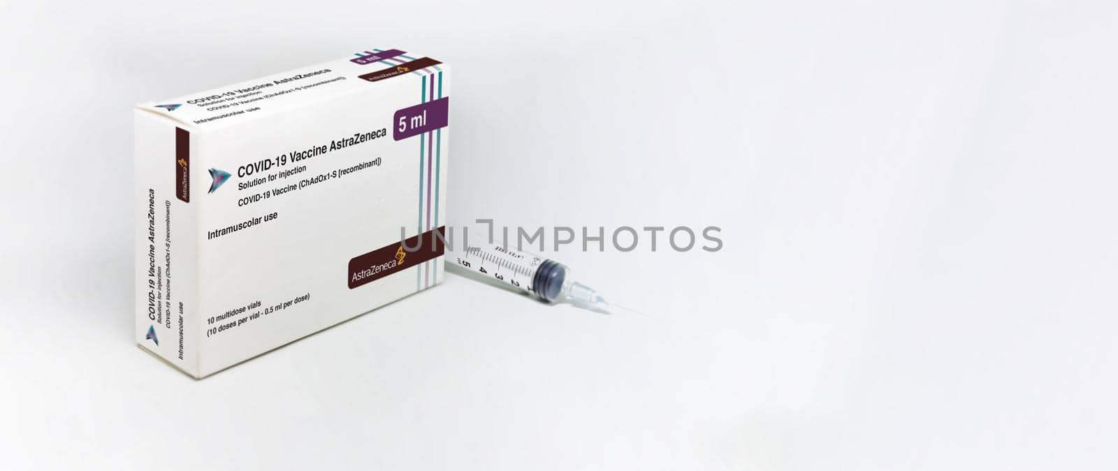 Cambridge, UK, february 5th 2021: A syringe next to the AstraZeneca Covid-19 Vaxzevria vaccine box by rarrarorro