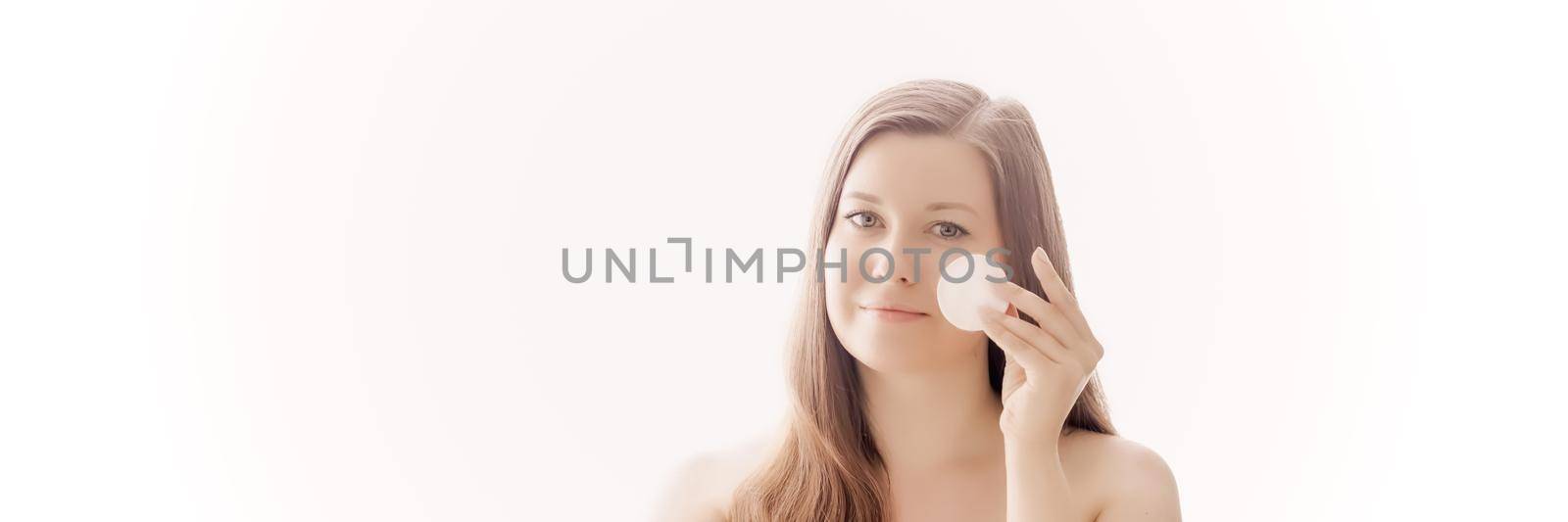 Beautiful woman with cotton pad, perfect skin and shiny hair as make-up, health and wellness concept. Face portrait of young female model for skincare cosmetics and luxury beauty ad design.