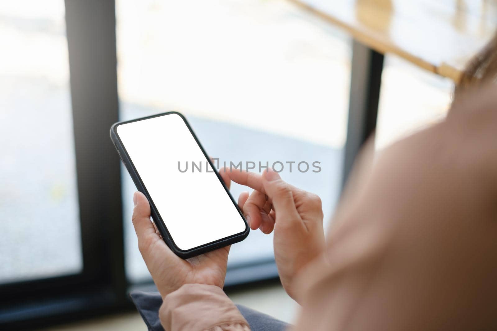 A woman hand holding smartphone device with blank screen. by itchaznong