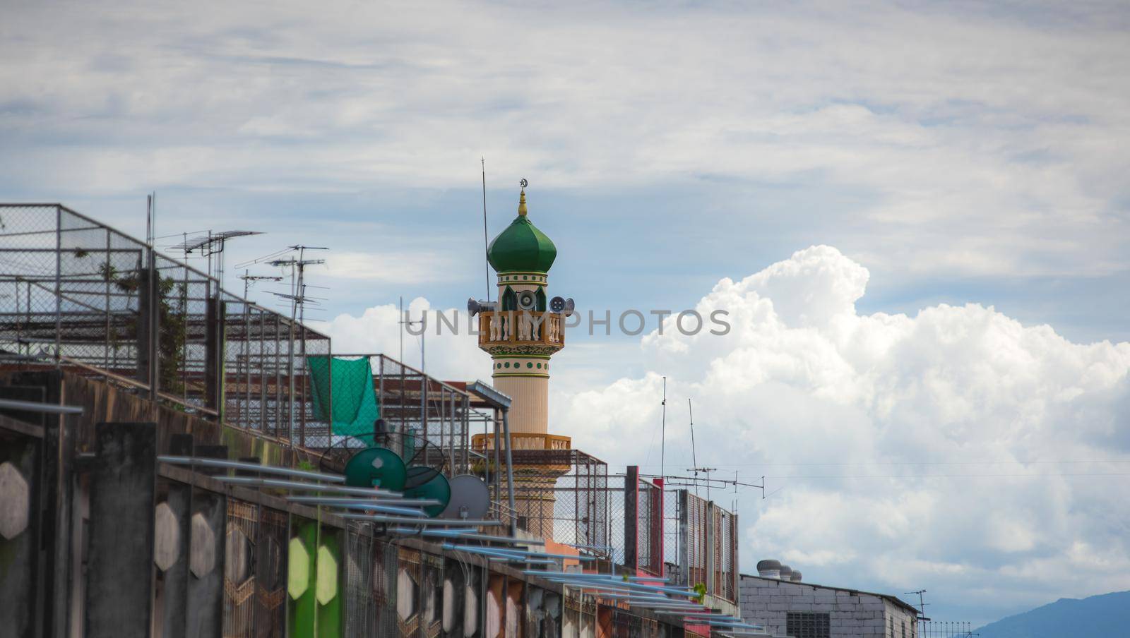 Islamic mosque with buildings around.