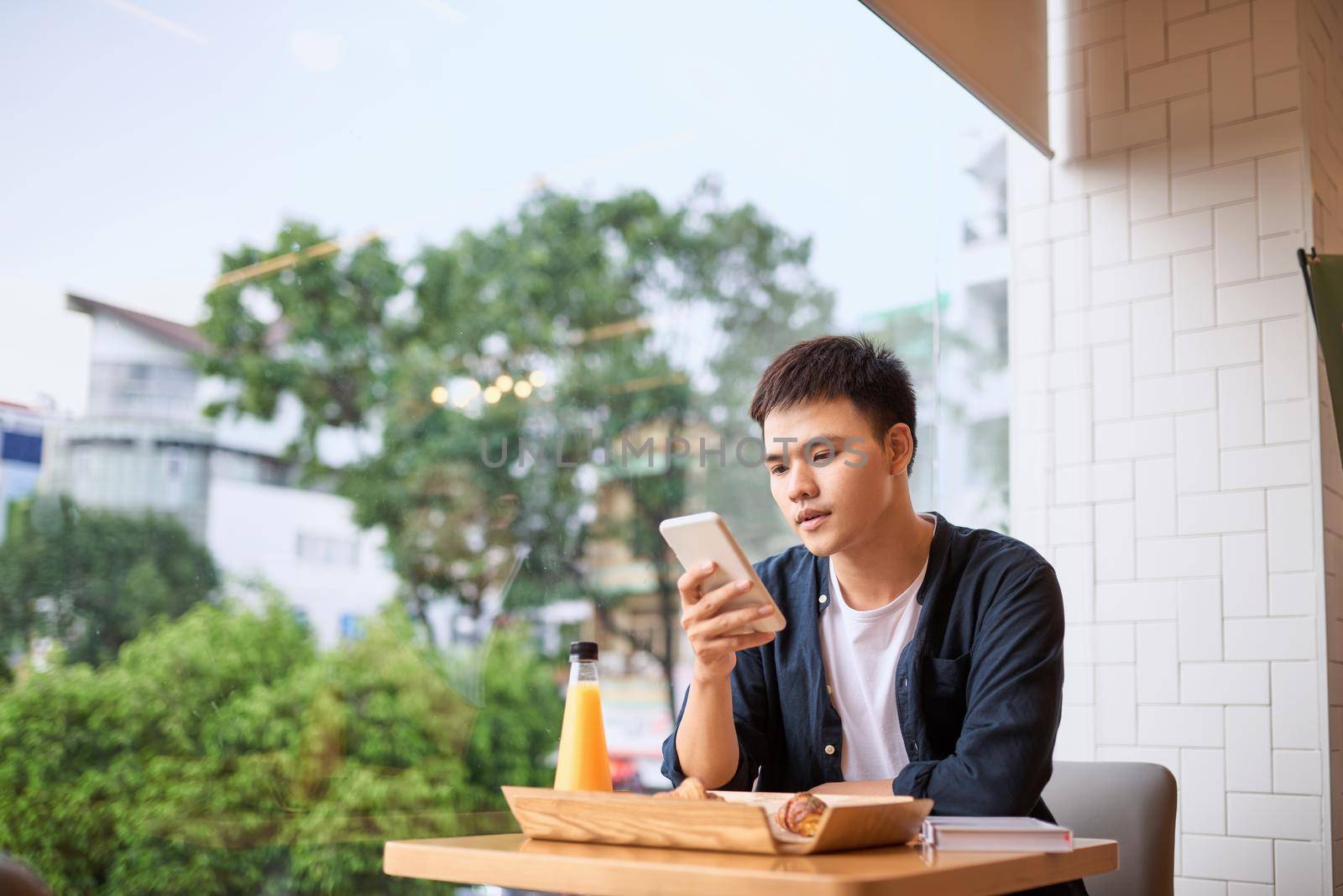 Men use phone on tea time,using mobile smart phone, Internet of things lifestyle with wireless communication and internet with smartphone. by makidotvn