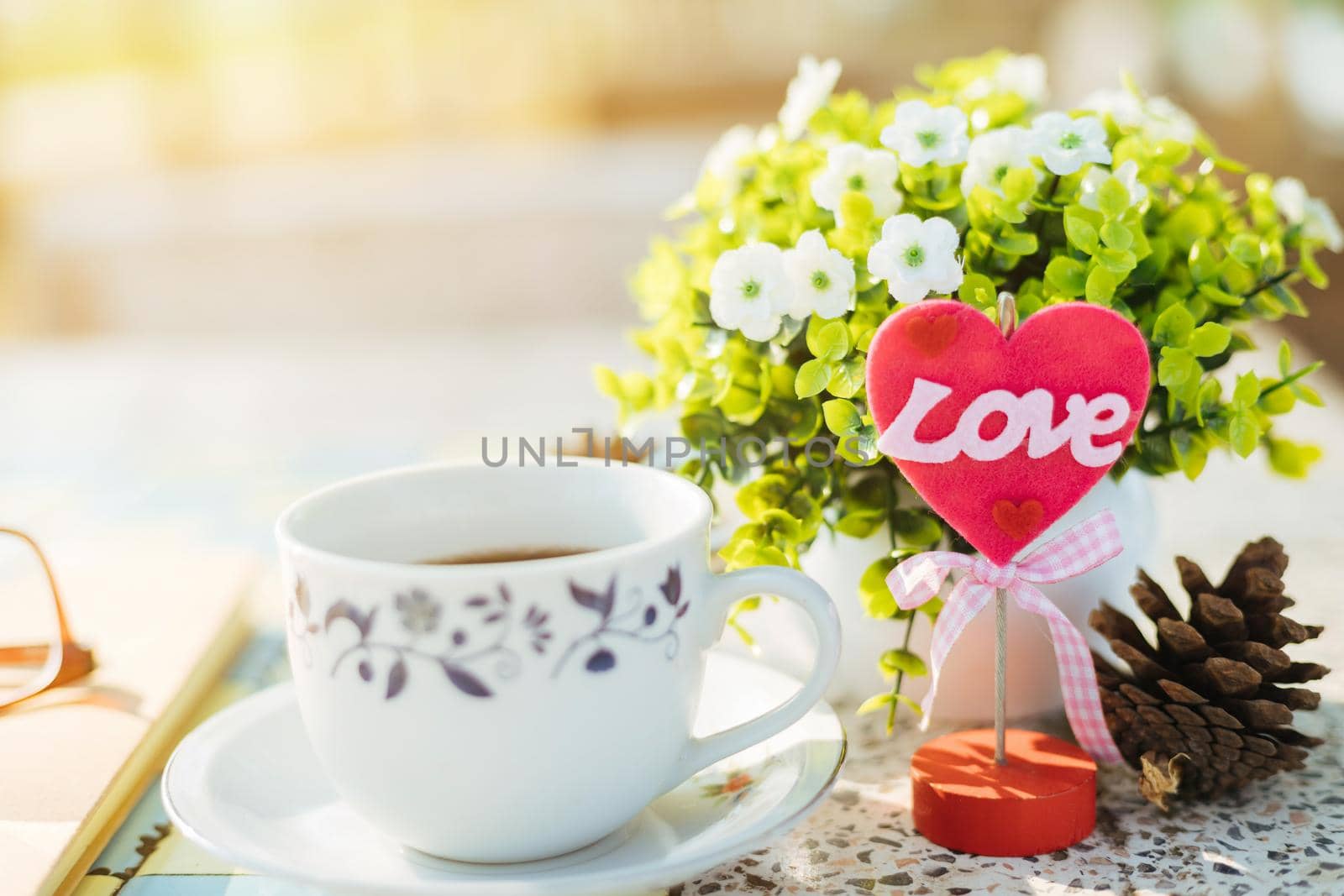 Close-up of empty notebook,spectacles and cup of coffee on Marble floor background. Love concept with heart desktop,Valentine's Day.