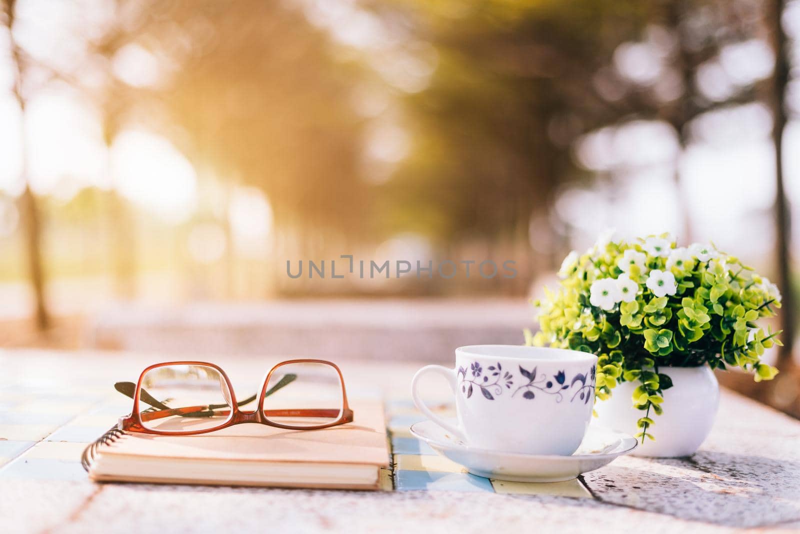 Close-up of empty notebook,spectacles and cup of coffee on Marble floor background. Love concept with heart desktop,Valentine's Day.