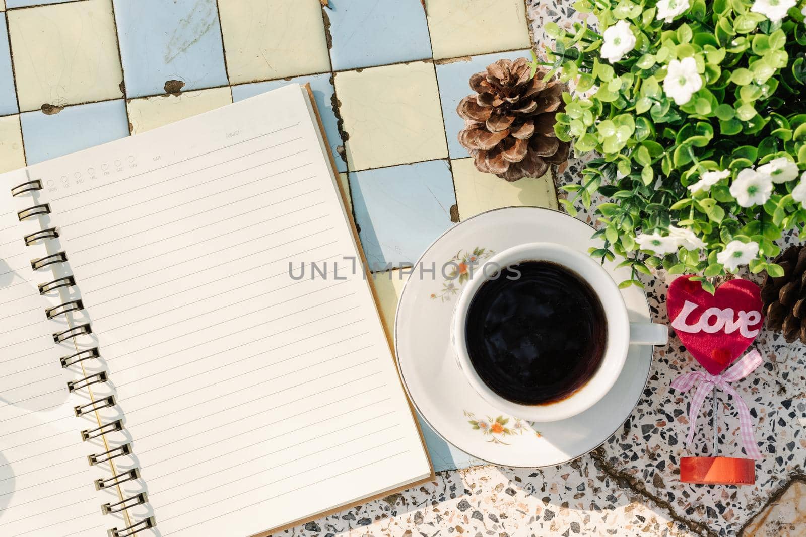 Top view image of empty notebook,spectacles and cup of coffee on Marble floor background. Love concept with heart desktop,Valentine's Day.