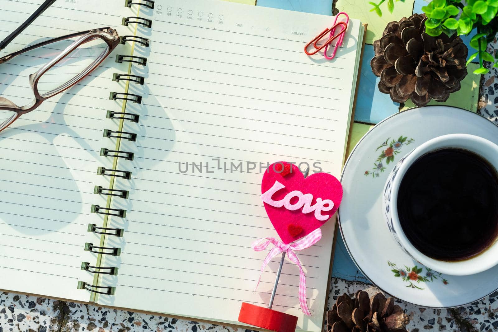Top view image of empty notebook,spectacles and cup of coffee on Marble floor background. Love concept with heart desktop,Valentine's Day. by tinapob2534