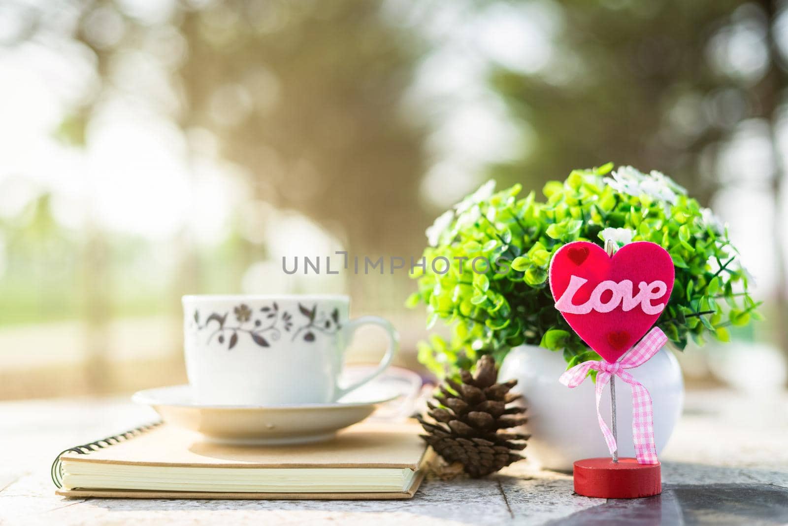 Close-up of empty notebook and cup of coffee on Marble floor background. Love concept with heart desktop,Valentine's Day. by tinapob2534