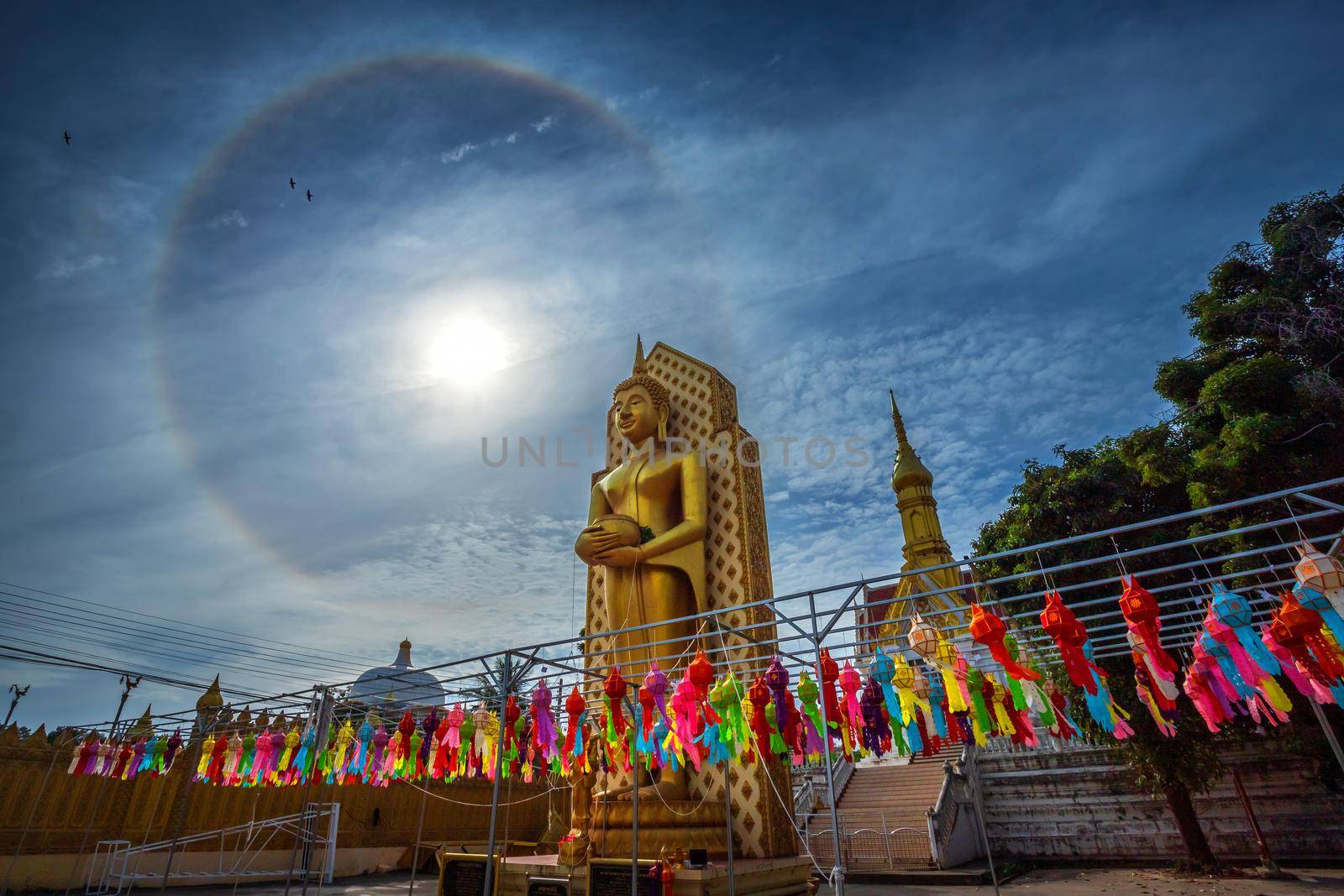 Sun halo with blue sky with Buddha statue at in Temple (Thai language:Wat Chan West) is a Buddhist temple It is a major tourist attraction Phitsanulok, Thailand