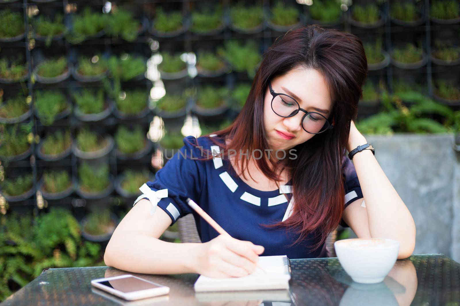 Asian young business woman between the thinking working make a note of something making and clock in summer park or office outdoor. by tinapob2534