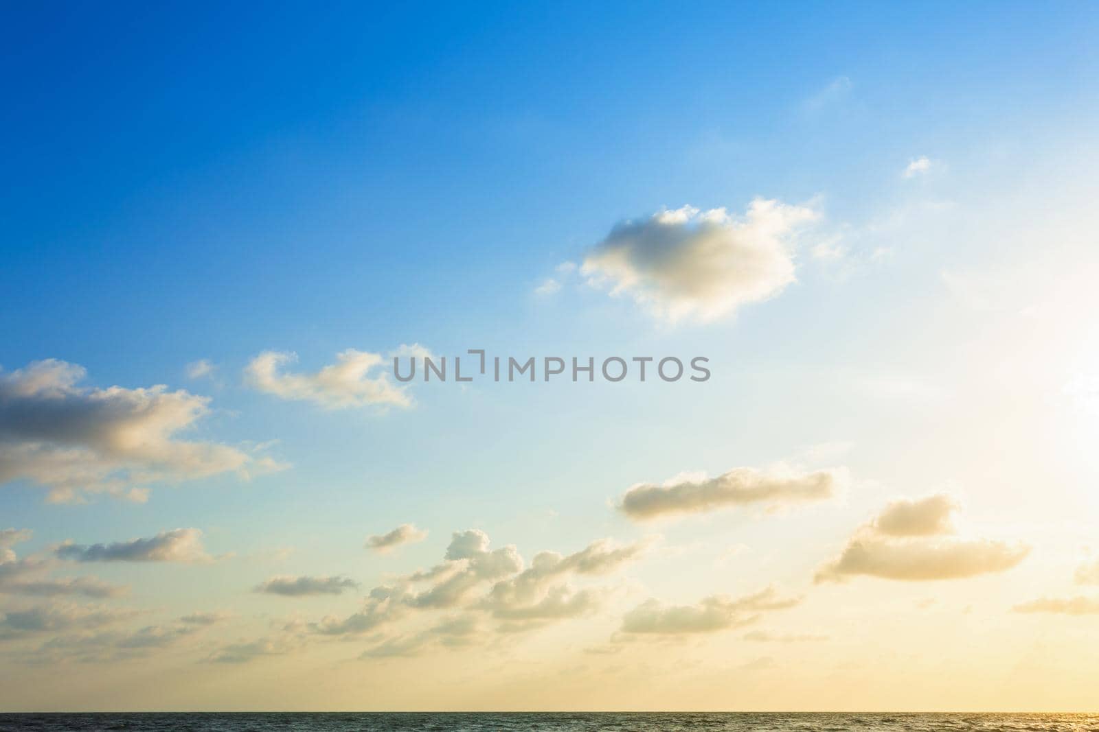 Beautiful early morning sunrise over the sea the horizon,blue sky background texture with white clouds sunset.