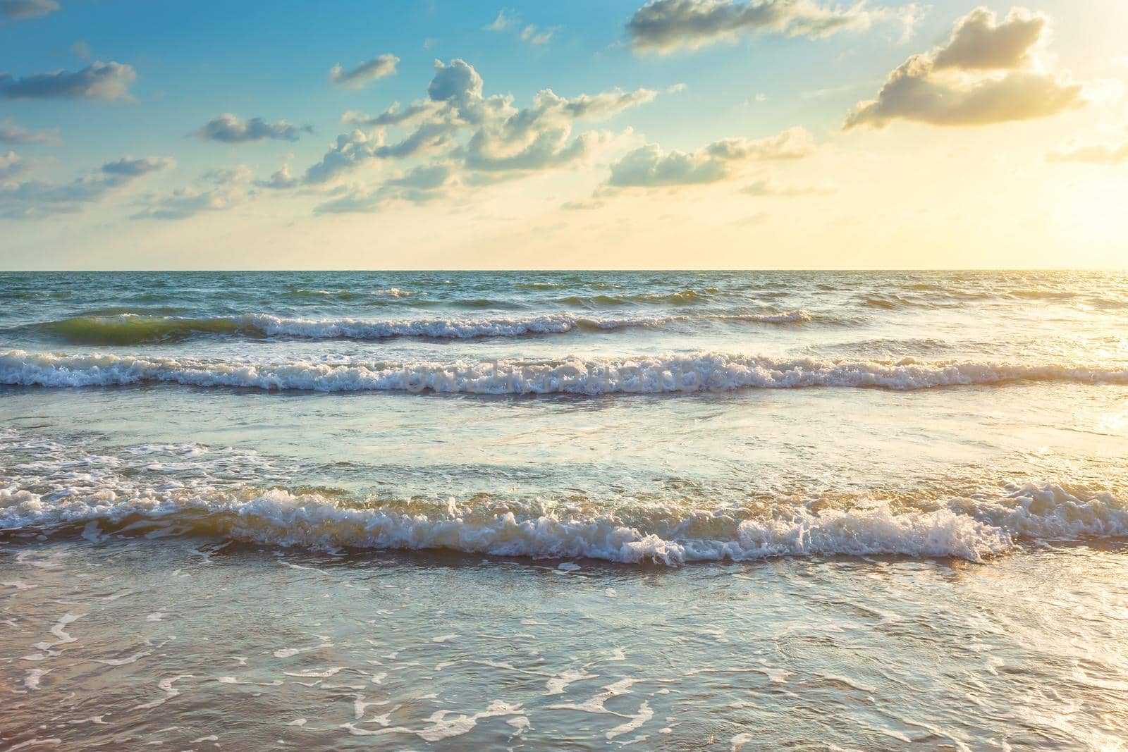 Beautiful Sunset over and Wave of the sea on the sand beach the horizon at Hat chao lao beach in Chanthaburi Thailand.