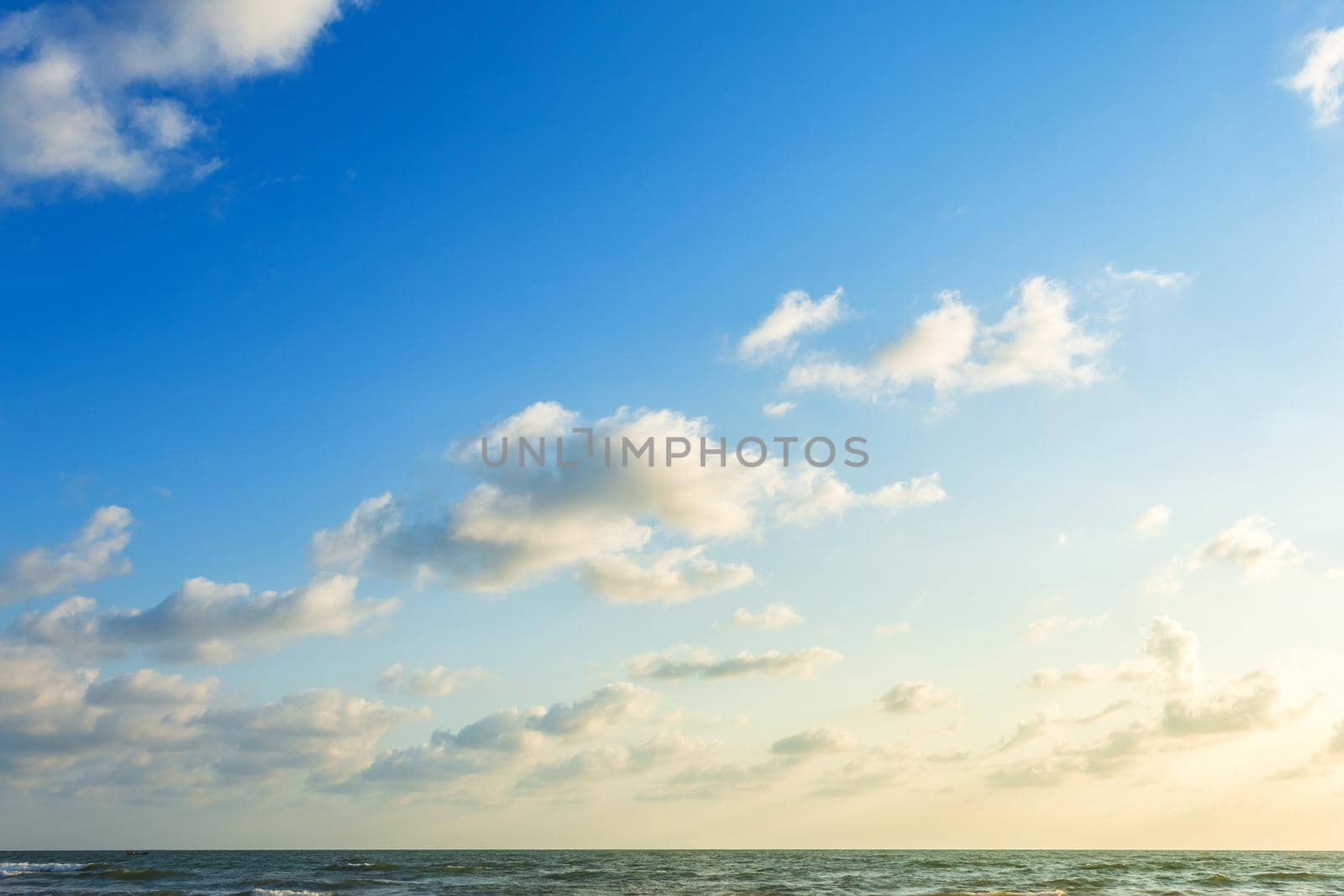 Beautiful early morning sunrise over the sea the horizon,blue sky background texture with white clouds sunset.