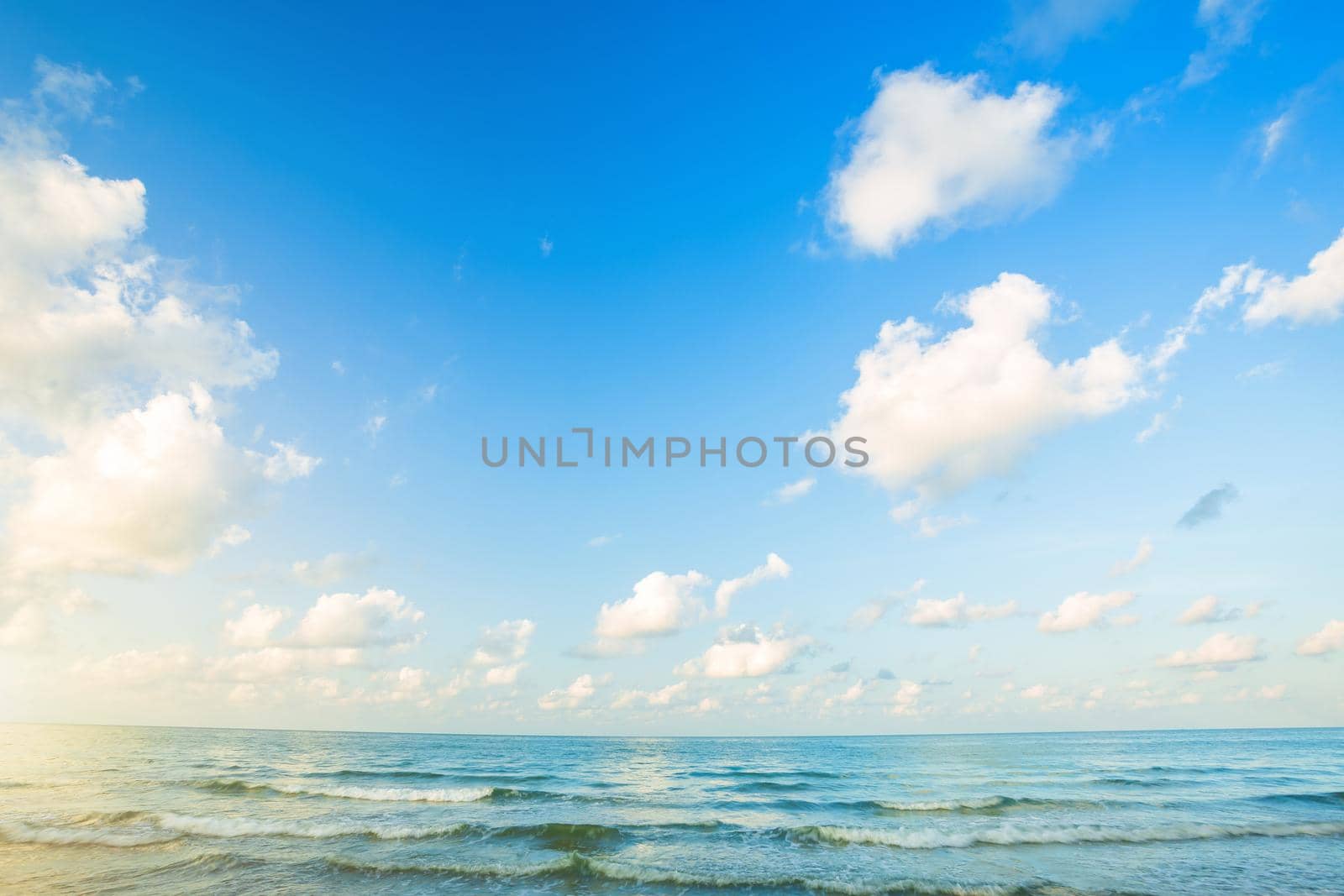 Beautiful early morning sunrise over the sea the horizon,blue sky background texture with white clouds sunset.