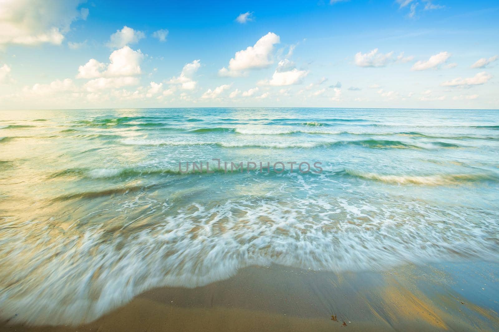 Beautiful early morning sunrise over and Wave of the sea on the sand beach the horizon at Hat chao lao beach in Chanthaburi Thailand.