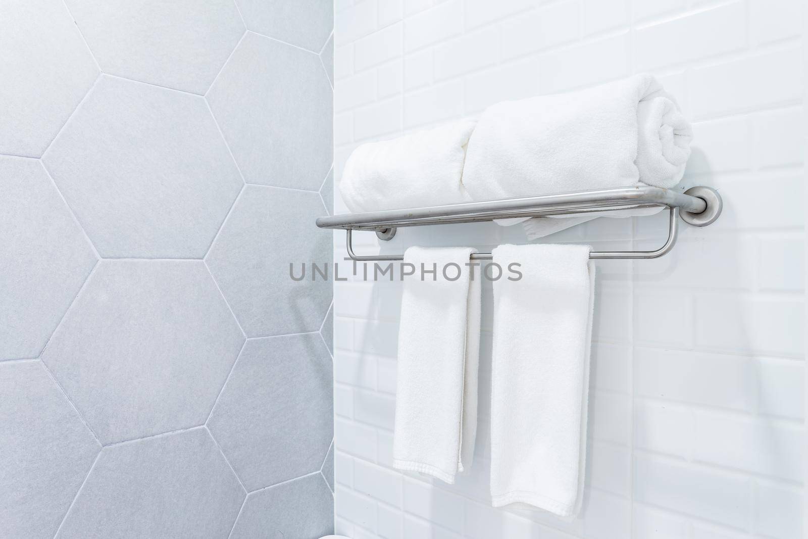 clean towels with hanger on wall bathroom interior background.