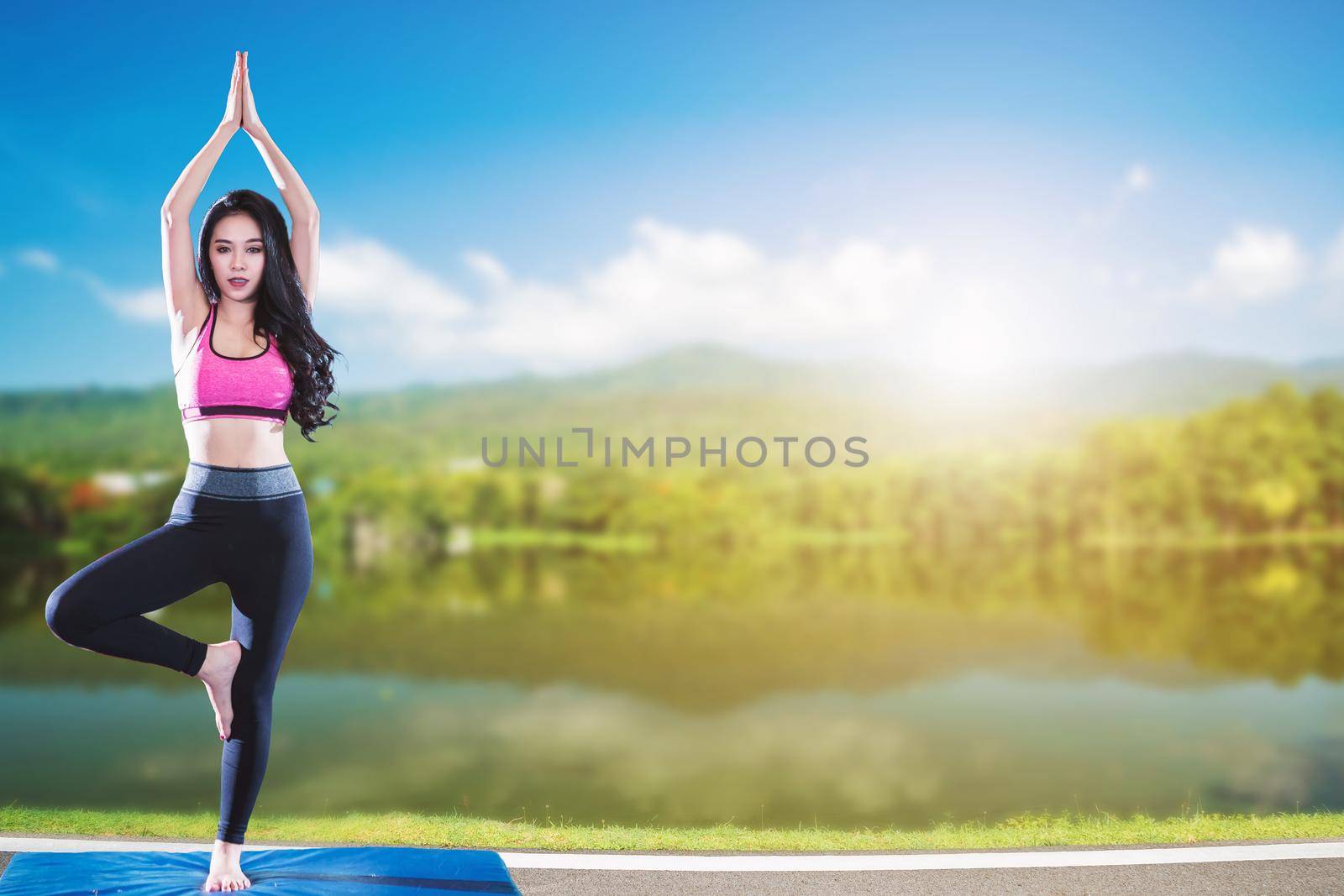 Asian women practicing yoga training at nature the park.