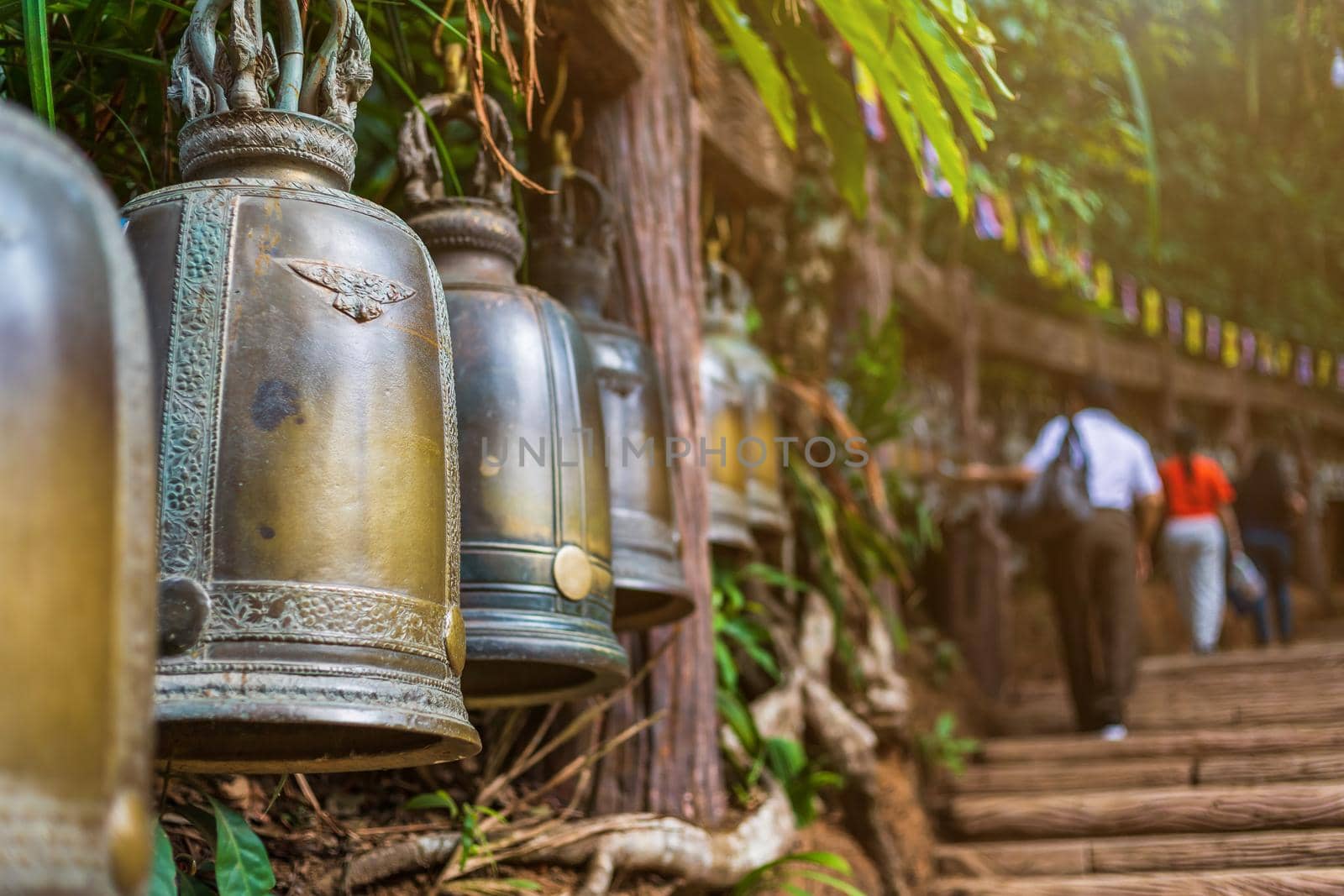 Old bell hangs on steel rail in The stone with the footprint of Lord Buddha at Khitchakut mountain It is a major tourist attraction Chanthaburi, Thailand.