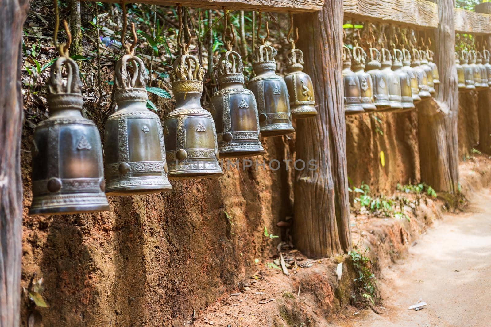 Old bell hangs on steel rail in The stone with the footprint of Lord Buddha at Khitchakut mountain It is a major tourist attraction Chanthaburi, Thailand.