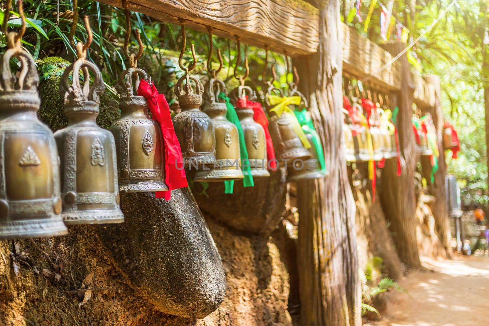 Old bell hangs on steel rail in The stone with the footprint of Lord Buddha at Khitchakut mountain It is a major tourist attraction Chanthaburi, Thailand.