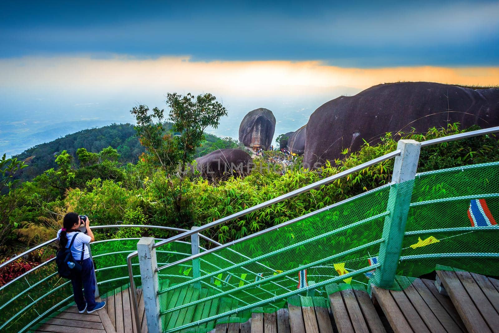 Tourists woman takes pictures of People traveling to worship The stone with the footprint of Lord Buddha at Khitchakut mountain It is a major tourist attraction Chanthaburi,Thailand.