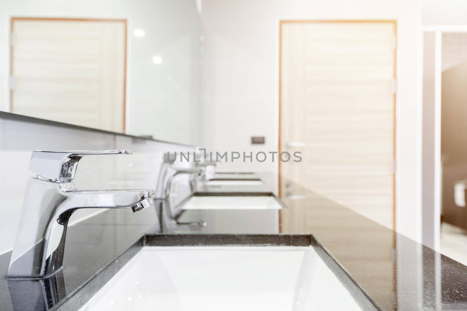 public Interior of bathroom with sink basin faucet lined up Modern design.