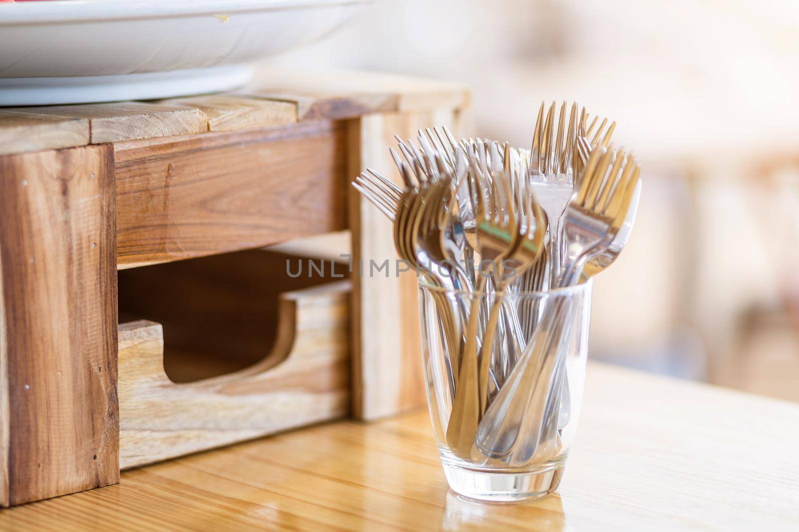 Many fork are placed with In the glass on the dining table decoration in hotel