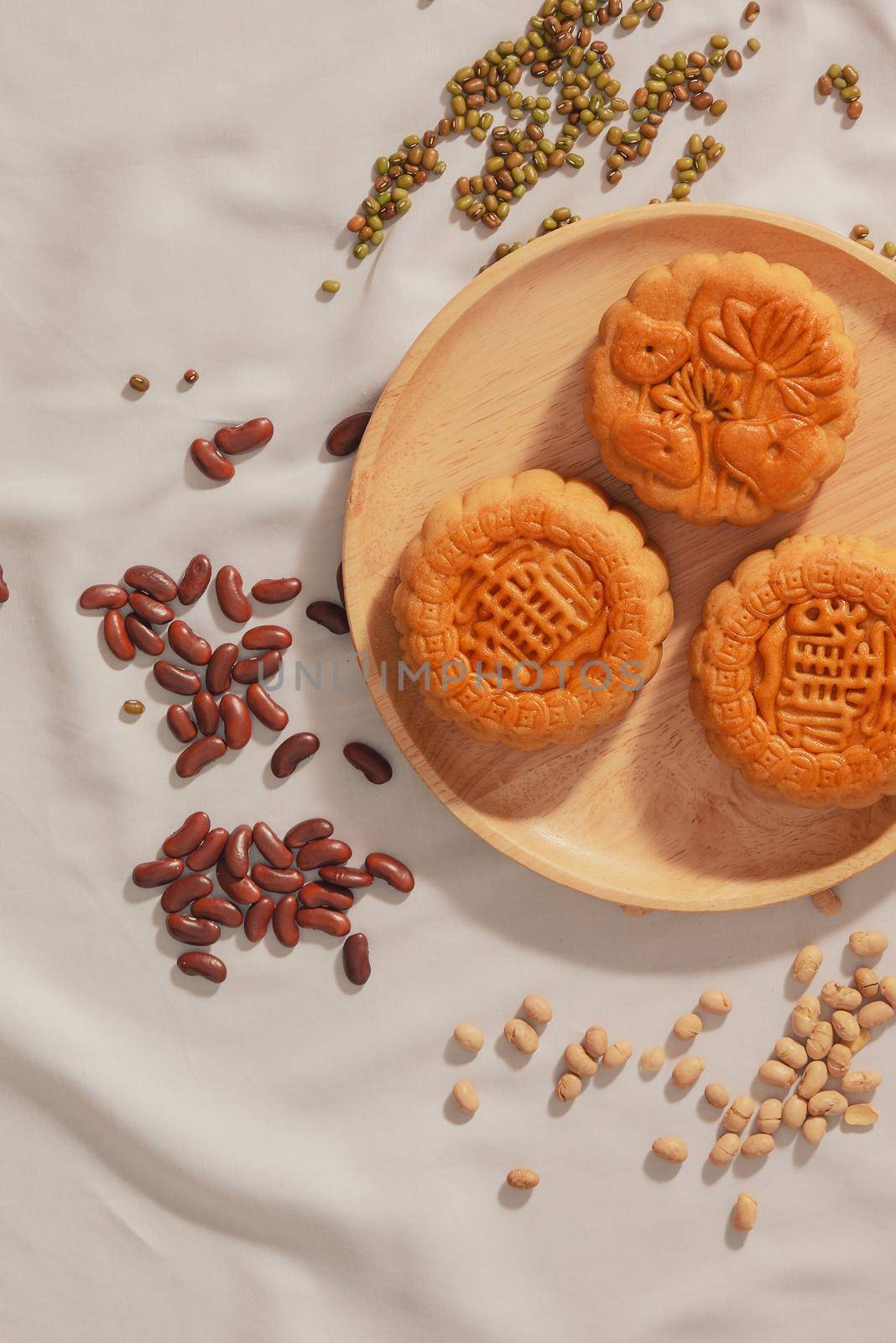 Flat lay conceptual of Mid-autumn Festival food mooncake. Text on cake mean Happiness.